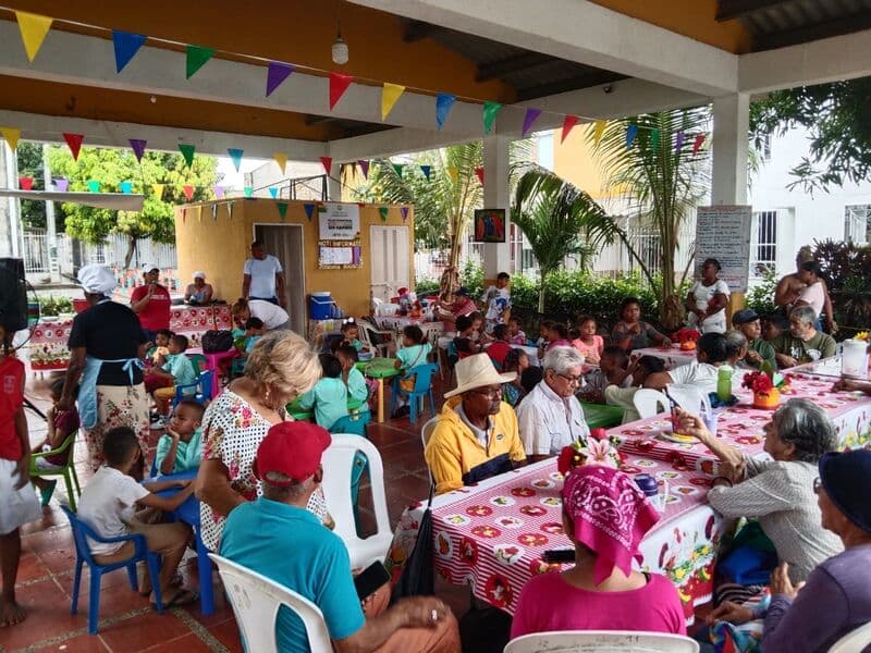 Community members and children sharing a meal